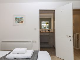A bedroom with a view of a bathroom at Beachstone in Salcombe