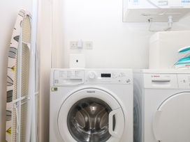 A laundry room with a washing machine and tumble dryer at Beachstone in Salcombe