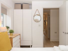A bedroom with a wardrobe and lamp at Beachstone in Salcombe