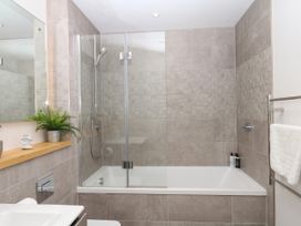 A bathroom with a shower and bathtub at Beachstone in Salcombe