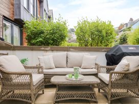 An outdoor seating area with a couch and coffee table at Beachstone in Salcombe