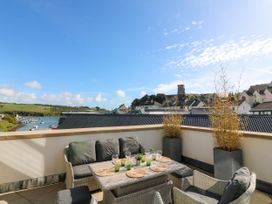 An outdoor terrace with furniture and a view at Beachstone in Salcombe