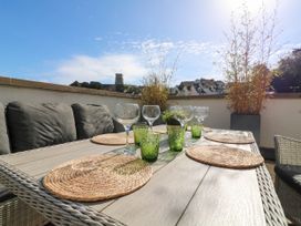 A terrace with an outdoor table set for dining at Beachstone in Salcombe