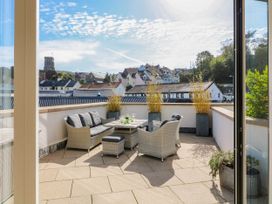 A terrace with outdoor seating and a view at Beachstone in Salcombe