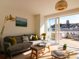 A living room with a sofa and coffee table at Beachstone in Salcombe