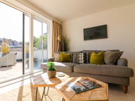 A living room with a sofa and coffee table at Beachstone in Salcombe