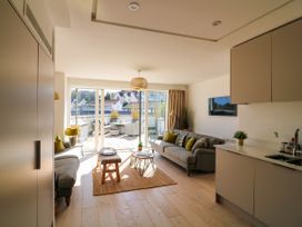 A living room with a sofa and coffee table at Beachstone in Salcombe