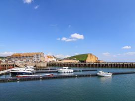 A view of boats docked at a pier near buildings at 16 Old Shipyard Centre West Bay
