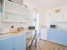 A kitchen with a toaster and radio at 16 Old Shipyard Centre in West Bay