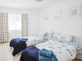 A bedroom with two beds and curtains at 16 Old Shipyard Centre West Bay