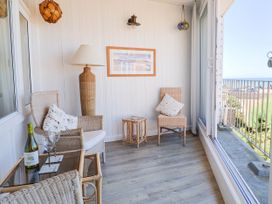 A conservatory with seating and a view at 16 Old Shipyard Centre West Bay