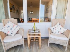 A living room with chairs and a table at 16 Old Shipyard Centre in West Bay