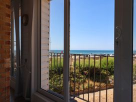 A view of the sea through a window at 16 Old Shipyard Centre, West Bay