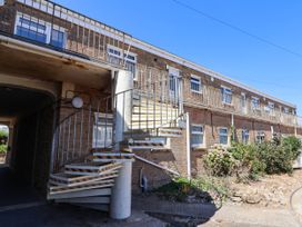 An exterior view of a building with a spiral staircase at 16 Old Shipyard Centre West Bay