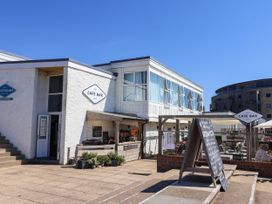 An outdoor cafe bar with a menu board at 16 Old Shipyard Centre in West Bay