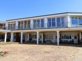 A building with balconies and outdoor seating at 16 Old Shipyard Centre, West Bay