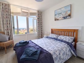 A bedroom with a bed and window view at 16 Old Shipyard Centre West Bay