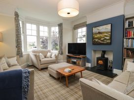 A living room with a sofa and television at Briargarth in Keswick