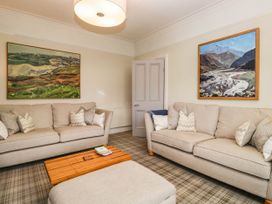A living room with sofas and paintings at Briargarth in Keswick