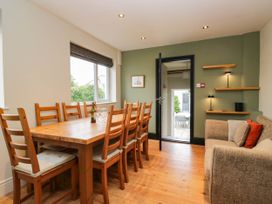 A dining room with a wooden table and chairs at Briargarth in Keswick