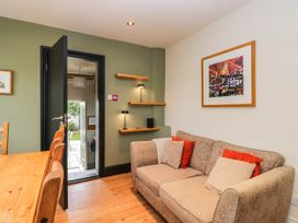 A dining room with a sofa and dining table at Briargarth Keswick