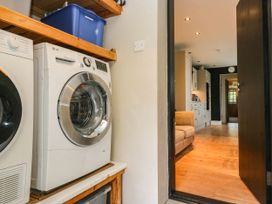A utility room with a washing machine and tumble dryer at Briargarth in Keswick