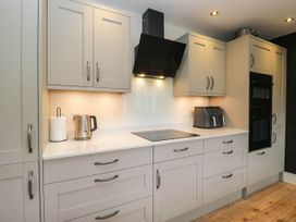A kitchen with cabinets and appliances at Briargarth in Keswick