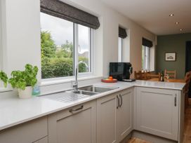 A kitchen with a sink and windows at Briargarth in Keswick