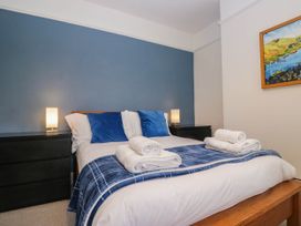 A bedroom with a bed and nightstands at Briargarth in Keswick