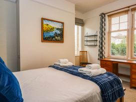 A bedroom with a bed and desk at Briargarth in Keswick