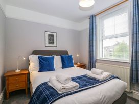 A bedroom with a bed and bedside table at Briargarth in Keswick