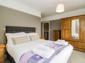 A bedroom with a bed and wardrobe at Briargarth in Keswick