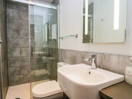 A bathroom with a shower, toilet, and sink at Briargarth in Keswick