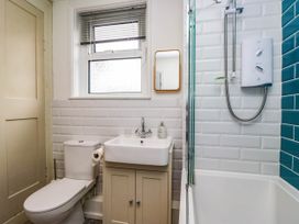 A bathroom with a toilet, sink, and shower at Briargarth in Keswick