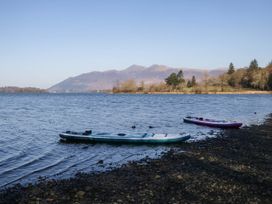 Two kayaks on the shore of a lake with mountains in the background at Briargarth in Keswick