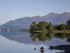 A scenic view of a lake with mountains and trees at Briargarth in Keswick