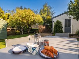 A table with croissants and coffee mugs in the garden at Briargarth in Keswick