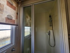 A shower with glass door and window at Whitley bay parkdean resorts - 52 Beechfield