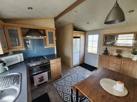 A kitchen with a dining table and appliances at Whitley bay parkdean resorts - 52 Beechfield, Whitley Bay