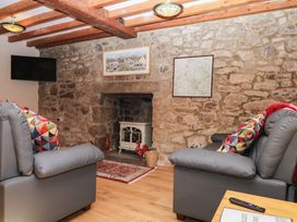 A living room with two sofas and a fireplace at Dashel Cottage at Dockwell Farm near Widecombe-In-The-Moor