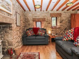 A living room with sofas and a coffee table at Dashel Cottage at Dockwell Farm near Widecombe-In-The-Moor
