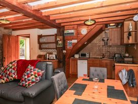A kitchen with dining area and sofa at Dashel Cottage at Dockwell Farm near Widecombe-In-The-Moor