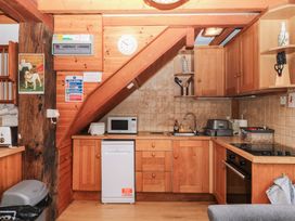 A kitchen with a microwave and a sink at Dashel Cottage at Dockwell Farm near Widecombe-In-The-Moor