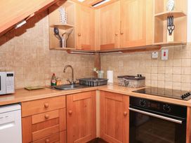 A kitchen with a sink and appliances at Dashel Cottage at Dockwell Farm near Widecombe-In-The-Moor