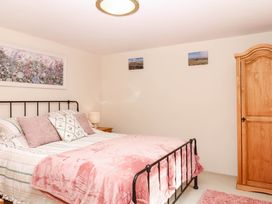 A bedroom with a bed and wardrobe at Dashel Cottage at Dockwell Farm near Widecombe-In-The-Moor