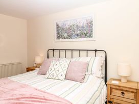 A bedroom with a bed and lamps at Dashel Cottage at Dockwell Farm near Widecombe-In-The-Moor