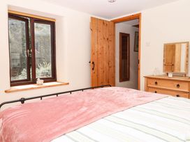 A bedroom with a bed and dresser at Dashel Cottage at Dockwell Farm near Widecombe-In-The-Moor