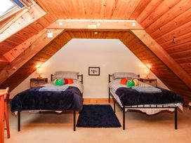 A bedroom with two beds and a rug at Dashel Cottage at Dockwell Farm near Widecombe-In-The-Moor