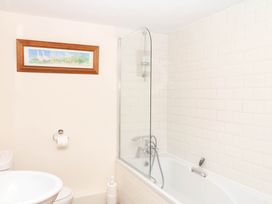 A bathroom with a bathtub and a toilet at Dashel Cottage at Dockwell Farm near Widecombe-In-The-Moor