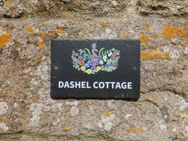 A slate sign with the text Dashel Cottage at Dockwell Farm near Widecombe-In-The-Moor